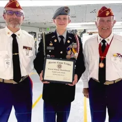 Two MCL Members presenting Student of the Month Award to a student